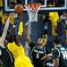 Michigan and Michigan State players reach for a rebound during the game on Sunday, Mar. 3. Daniel Brenner I AnnArbor.com